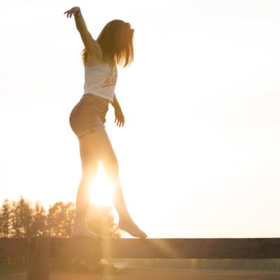 woman-walking-on-fence-1548769 woman-walking-on-fence-1548769